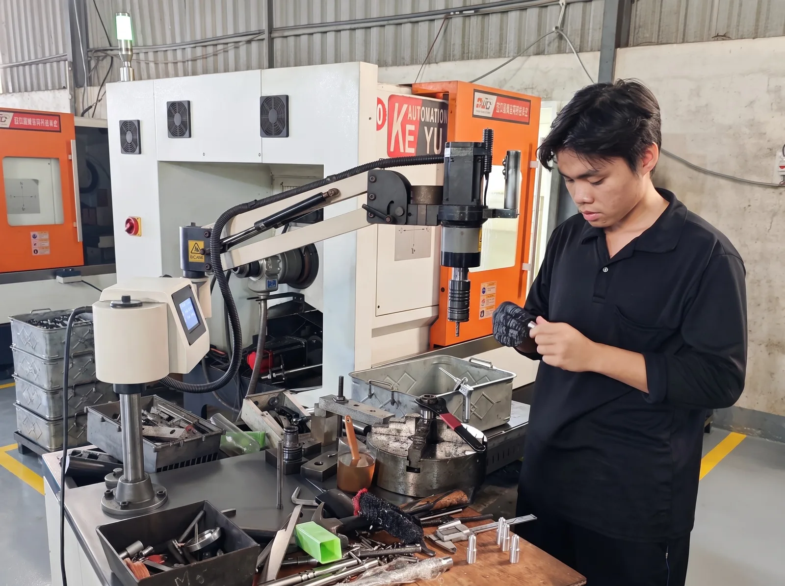 An operator at an arm tapping station
