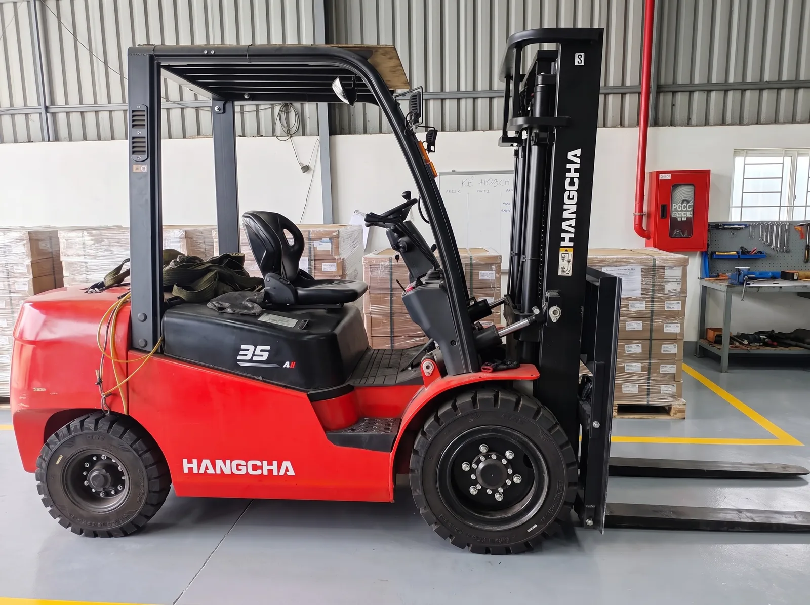 A forklift at the loading area with palletized cartons
