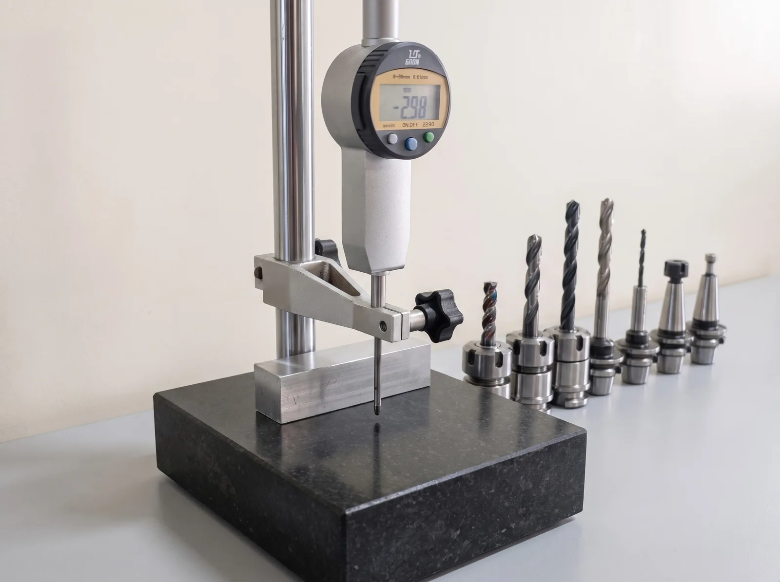 A digital height gauge on a granite surface plate