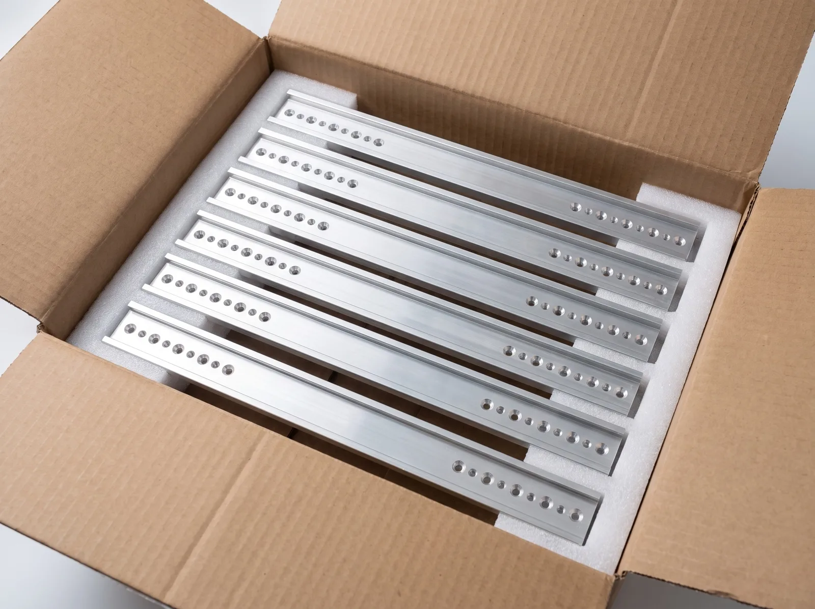 Machined aluminum profiles packed in foam in a carton